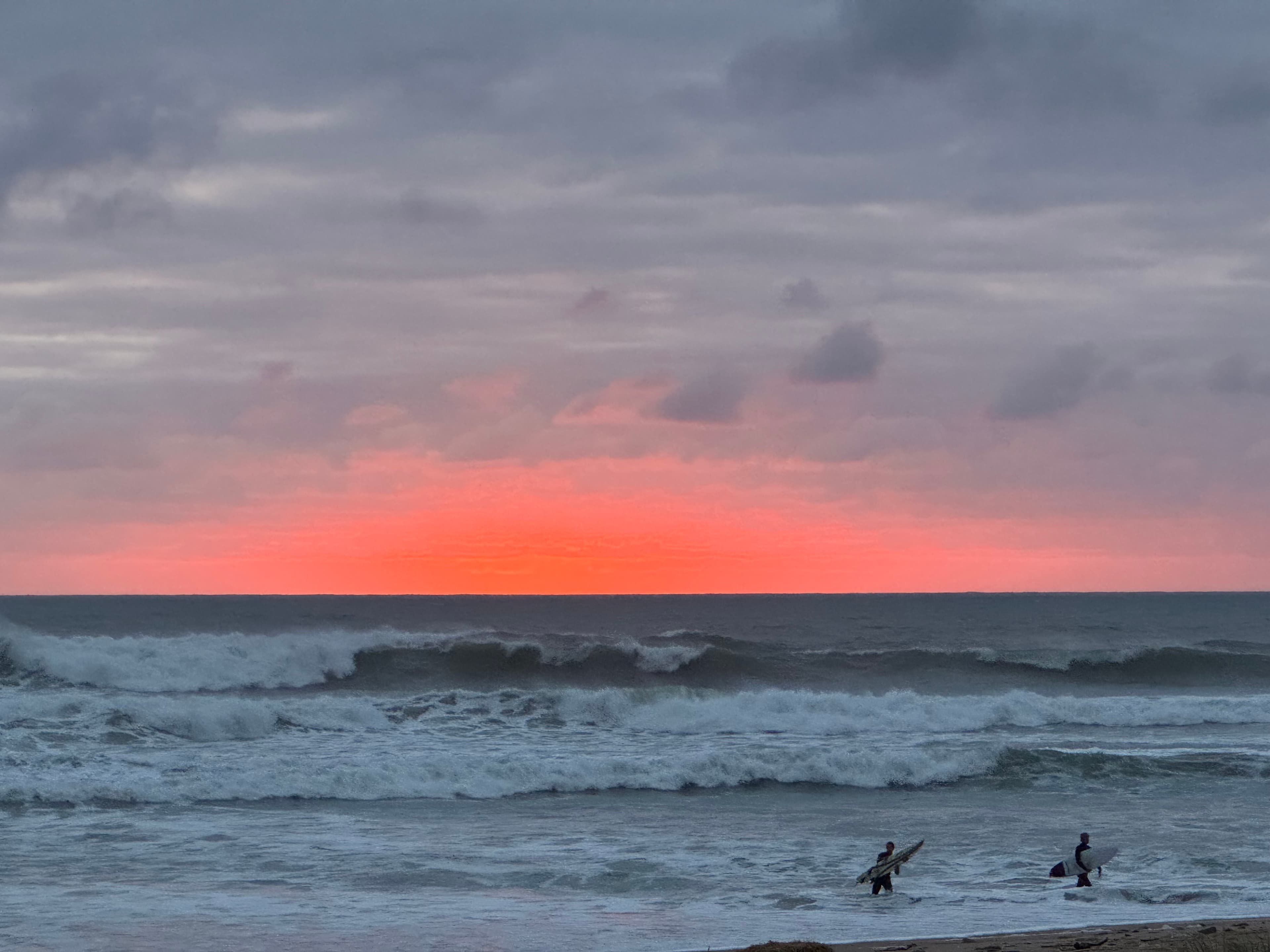 Surfers at sunset in Ericeira